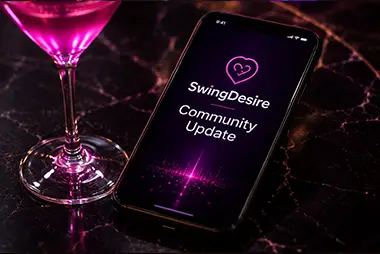 Smartphone displaying SwingDesire community updates beside a pink cocktail on a marble table.